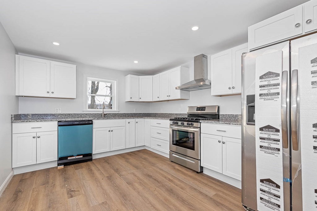40 Everett Avenue Somerville, MA 02145 - Photo 15 of 21 a kitchen with granite countertop white cabinets and white appliances