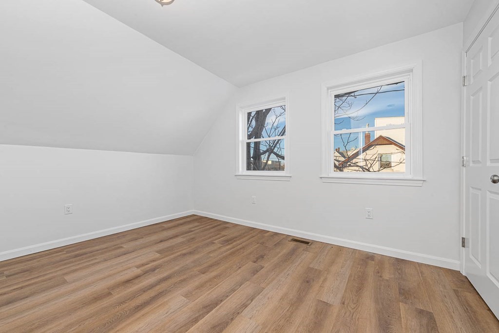 40 Everett Avenue Somerville, MA 02145 - Photo 20 of 21 an empty room with wooden floor and window