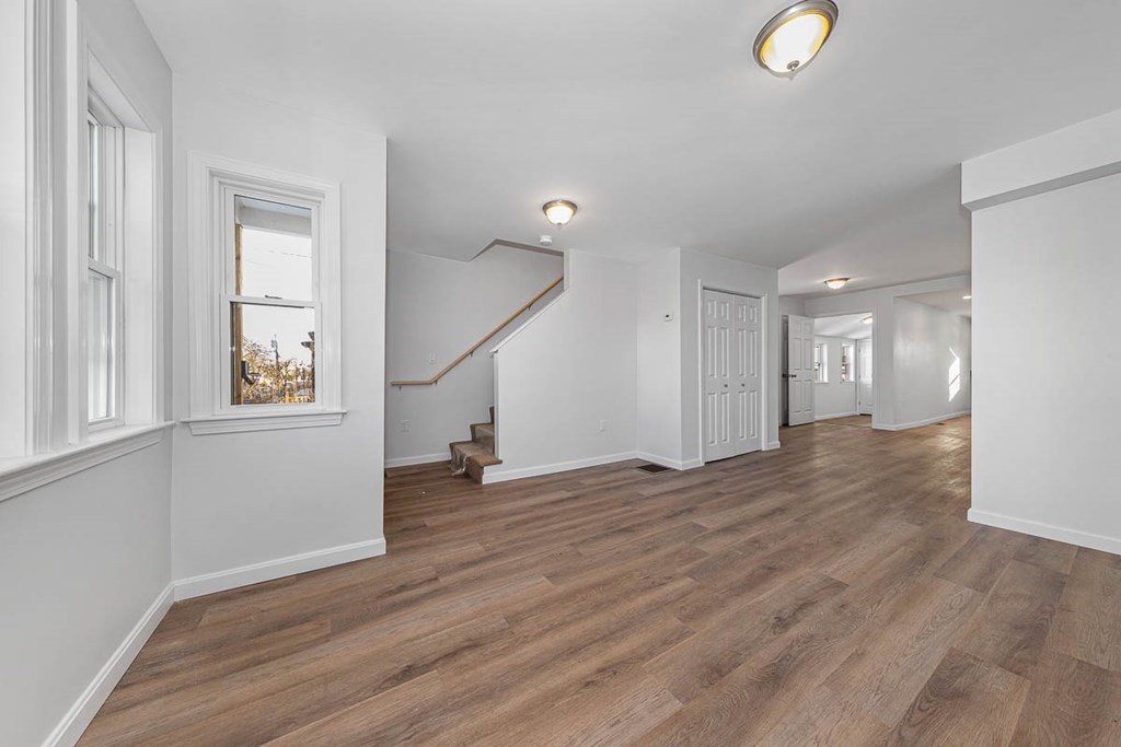 40 Everett Avenue Somerville, MA 02145 - Photo 7 of 21 a view of an empty room with wooden floor and a window