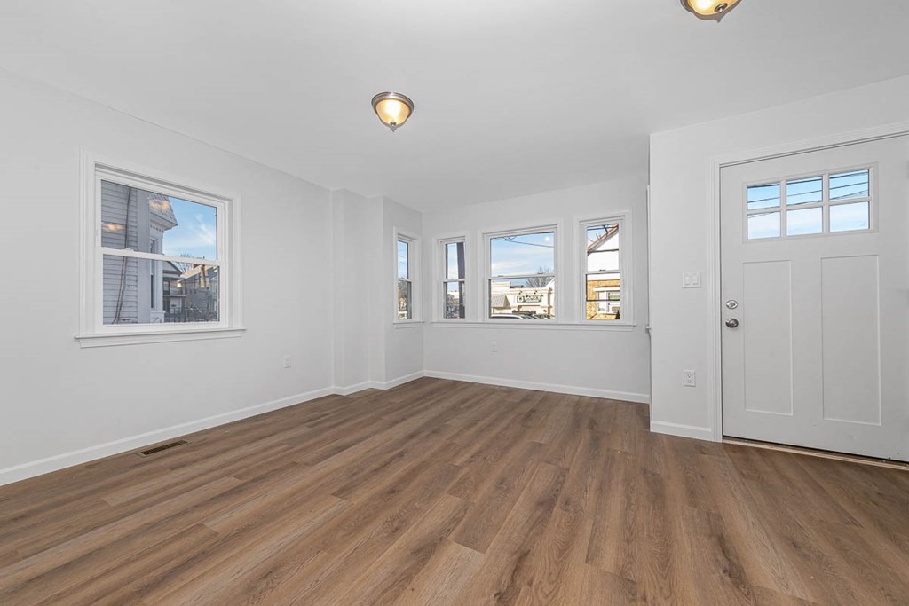 40 Everett Avenue Somerville, MA 02145 - Photo 8 of 21 a view of an empty room with window and wooden floor