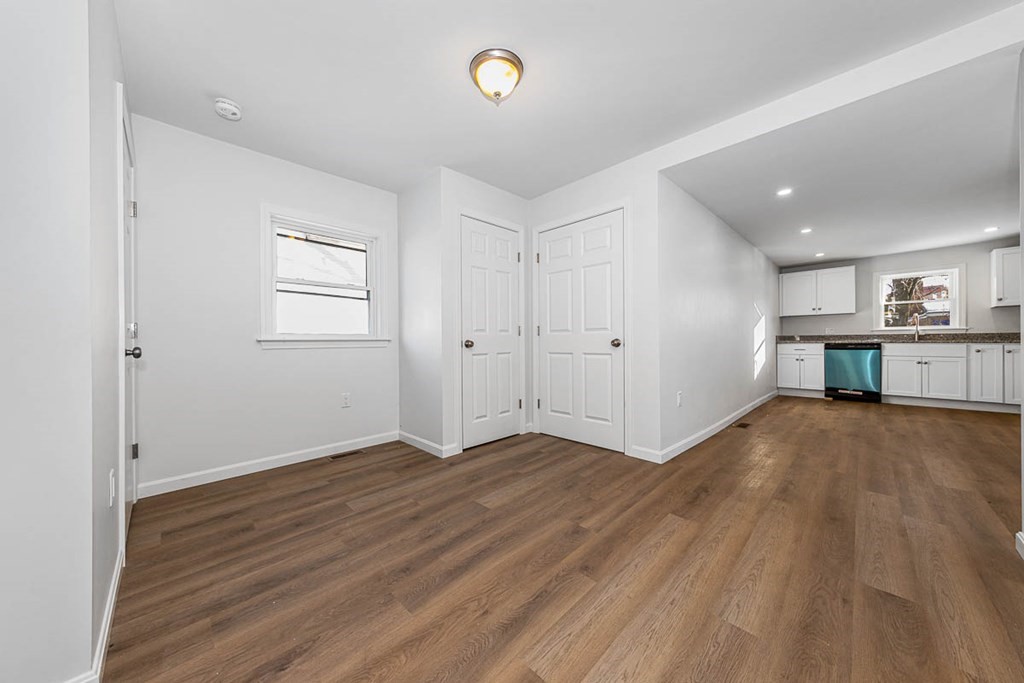 40 Everett Avenue Somerville, MA 02145 - Photo 9 of 21 an empty room with wooden floor and windows