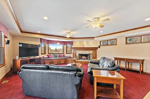 a living room with fireplace furniture and a flat screen tv