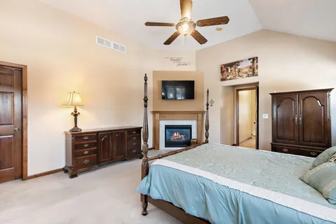 a spacious bedroom with a bed and a fireplace