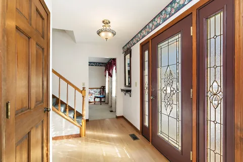 a view of an entryway with wooden floor and windows