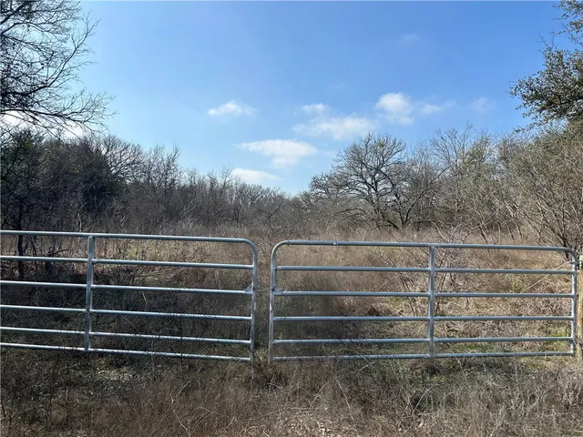 a view of a fence with a big yard