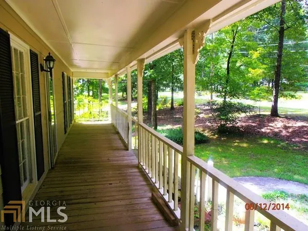 a view of a porch with wooden floor and outdoor space