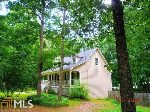 a view of a house with a yard and potted plants