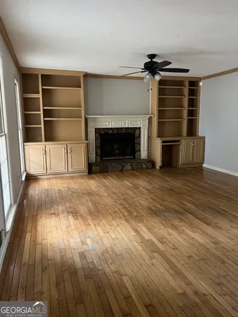 wooden floor in an empty room with a fireplace