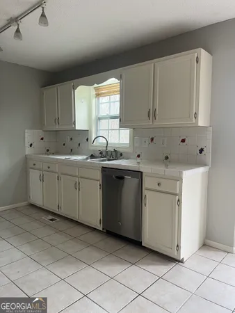 a utility room with cabinets washer and dryer