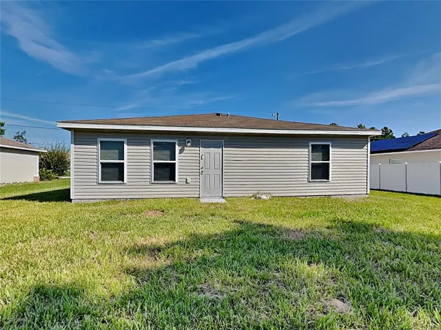 a backyard of a house with lots of green space