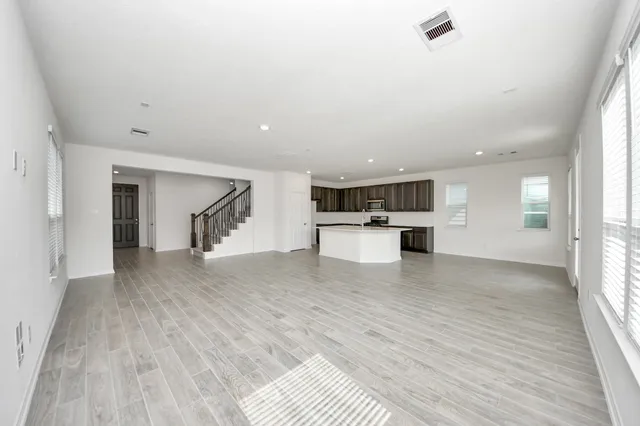 a view of a kitchen with a sink and a refrigerator