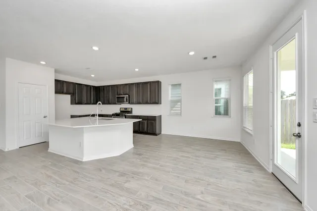 a kitchen with white cabinets and white appliances