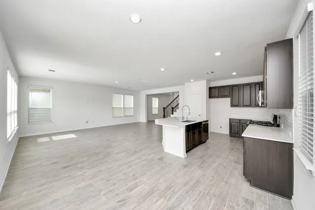 a large white kitchen with a large window