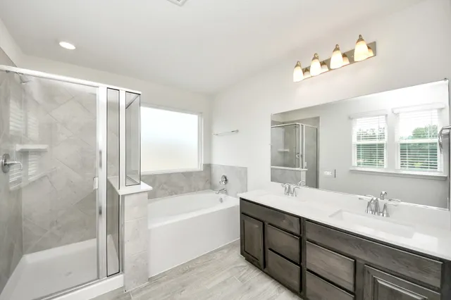 a bathroom with a double vanity sink and a mirror