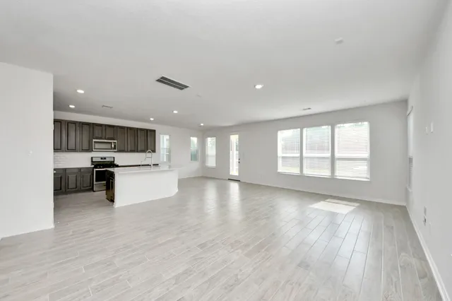 a view of kitchen with cabinets and wooden floor