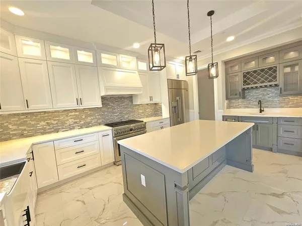 a kitchen with a refrigerator a sink and dishwasher with wooden floor