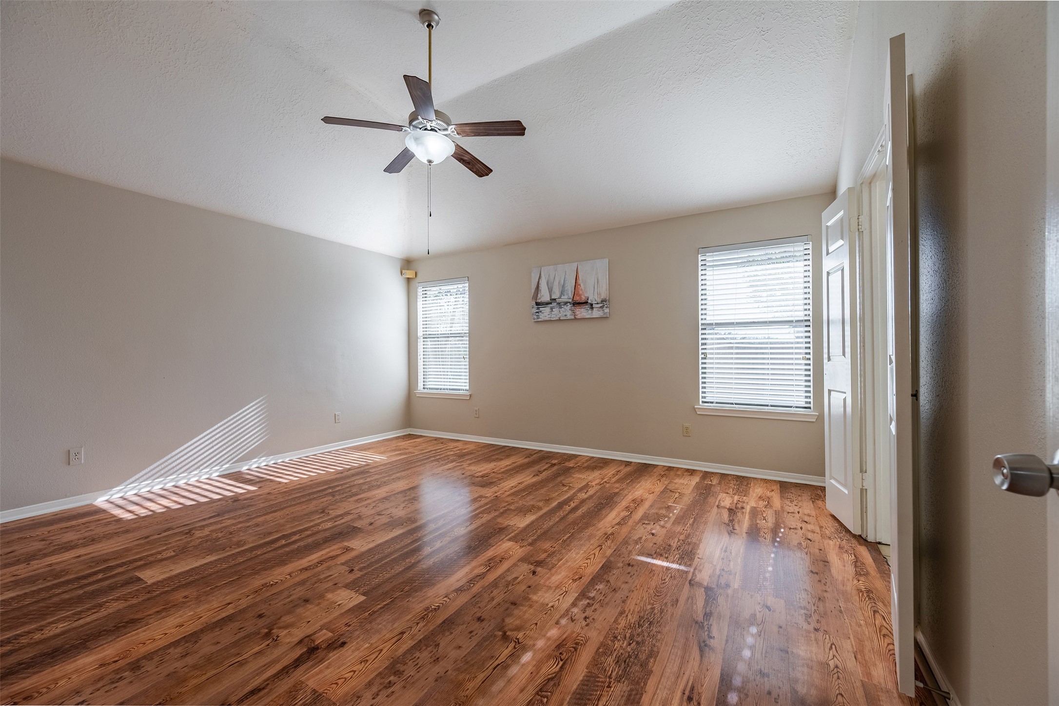 13623 Bonilla Lane Houston, TX 77083 - Photo 24 of 34 a view of empty room with wooden floor and fan