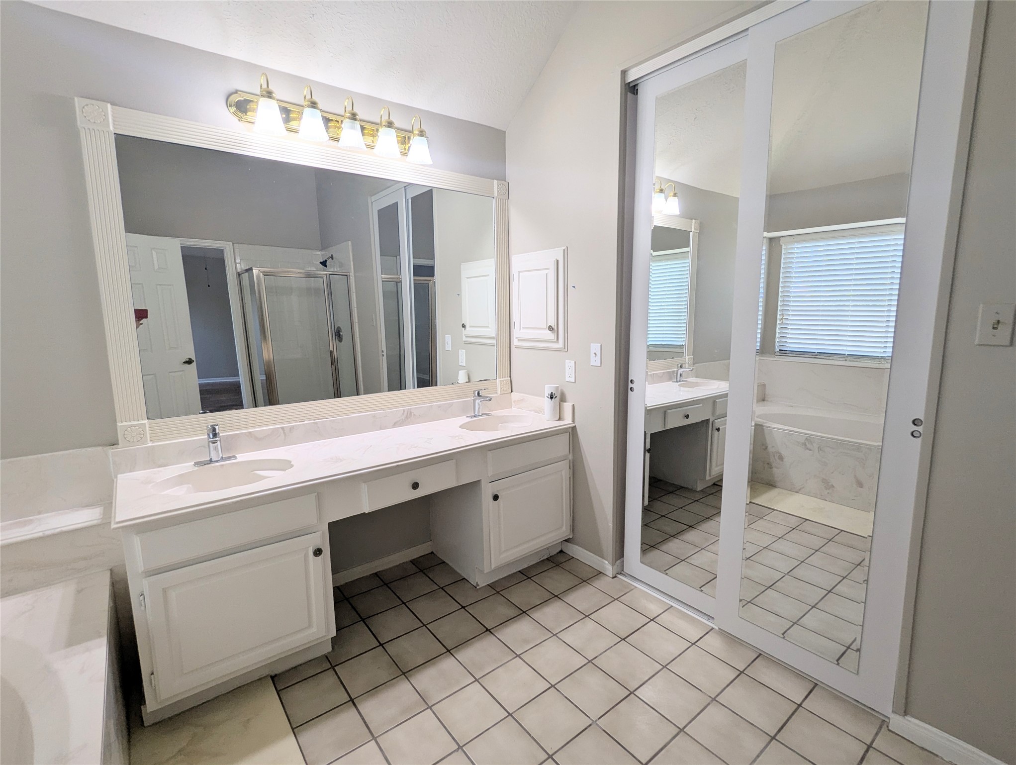 13623 Bonilla Lane Houston, TX 77083 - Photo 29 of 34 a spacious bathroom with a granite countertop sink mirror and