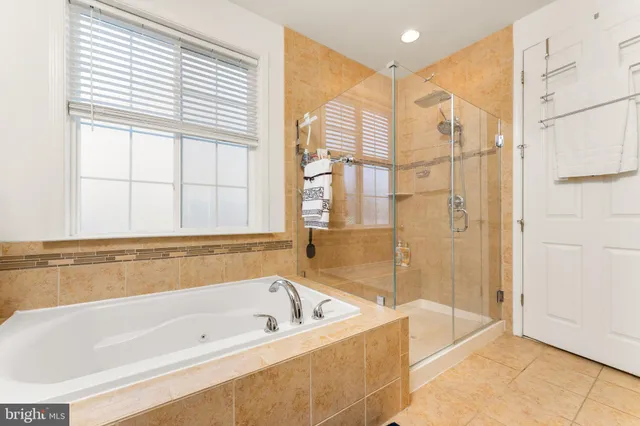 a bathroom with a bathtub and a shower