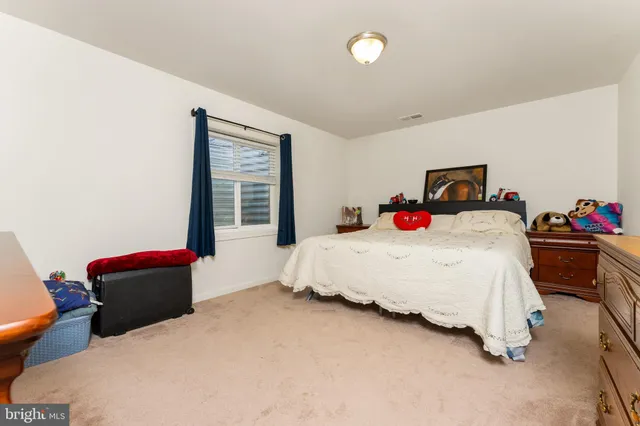 a spacious bedroom with a bed and a window