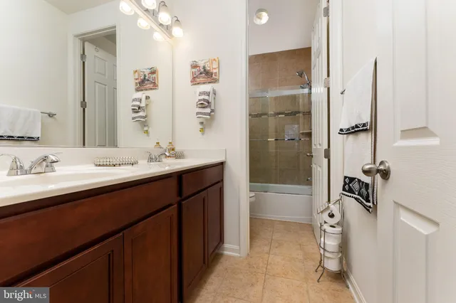 a bathroom with a double vanity sink a mirror and a shower