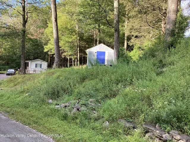a view of a house with a yard and sitting area