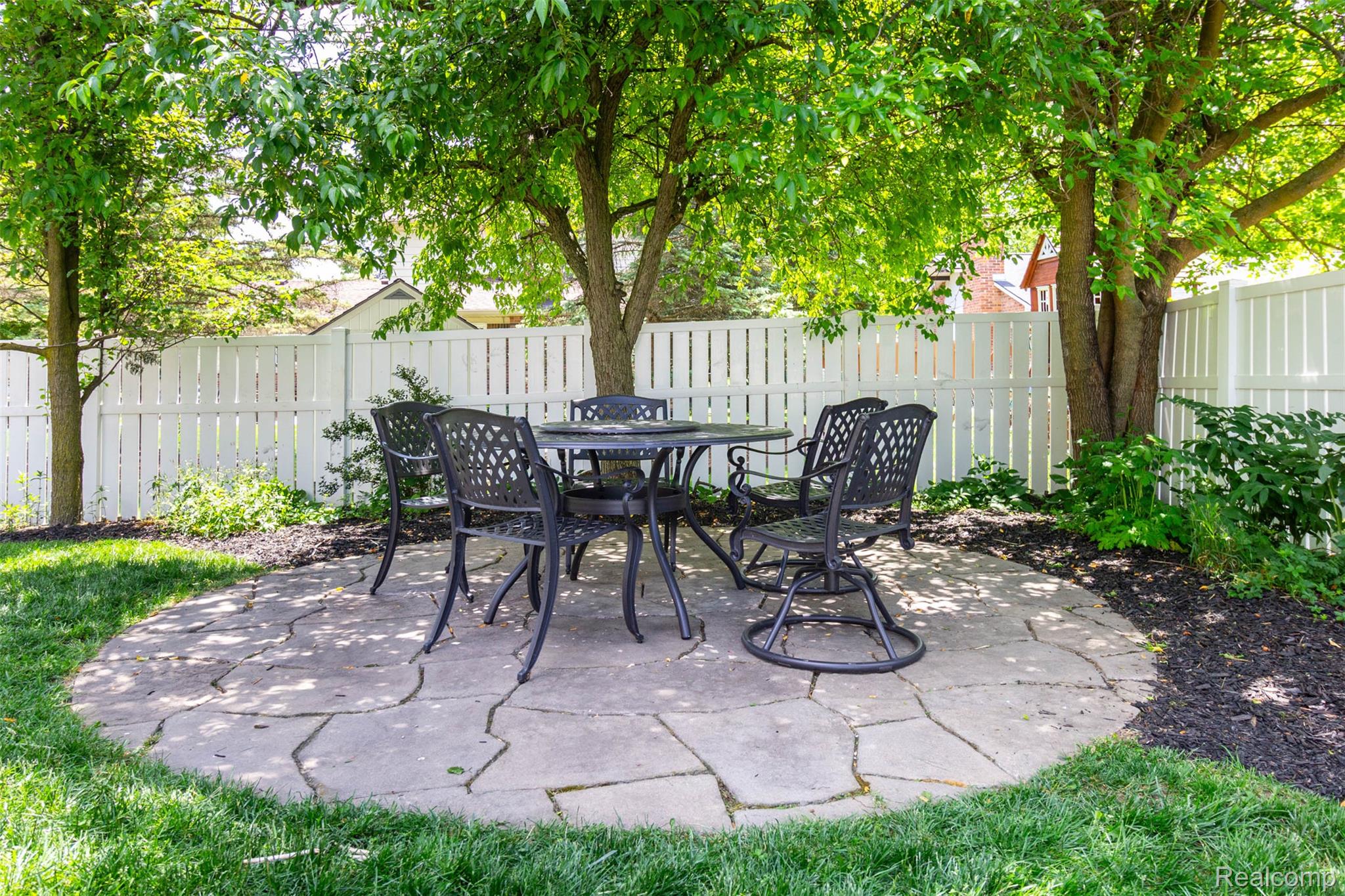 36039 Curtis Road Livonia, MI 48152 - Photo 51 of 61 Circular flagstone patio surrounded by manicured lawn and mature trees