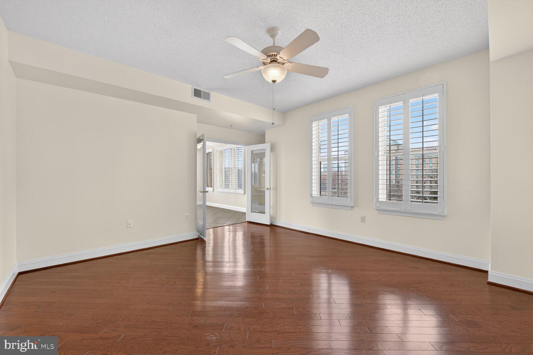 11776 Stratford House Place, Unit 502 Reston, VA 20190 - Photo 15 of 35 a view of an empty room with wooden floor and a window