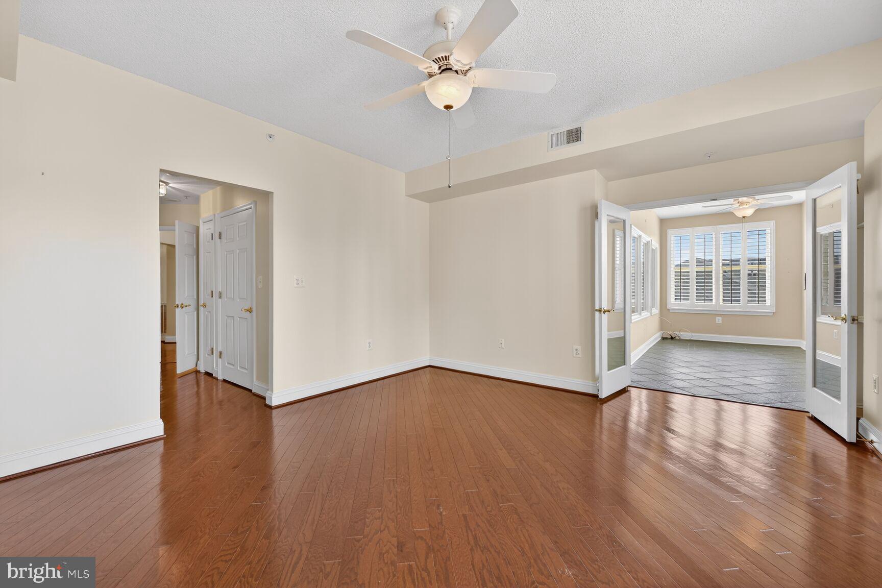 11776 Stratford House Place, Unit 502 Reston, VA 20190 - Photo 15 of 34 an empty room with wooden floor and windows