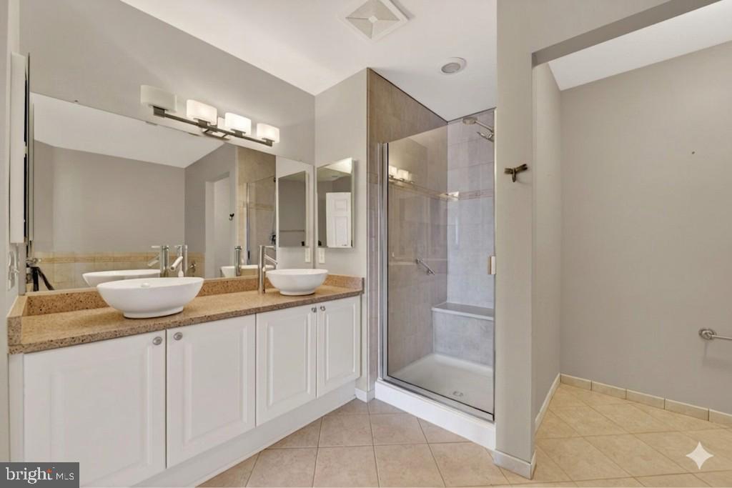 11776 Stratford House Place, Unit 502 Reston, VA 20190 - Photo 16 of 34 a bathroom with a granite countertop sink and a mirror