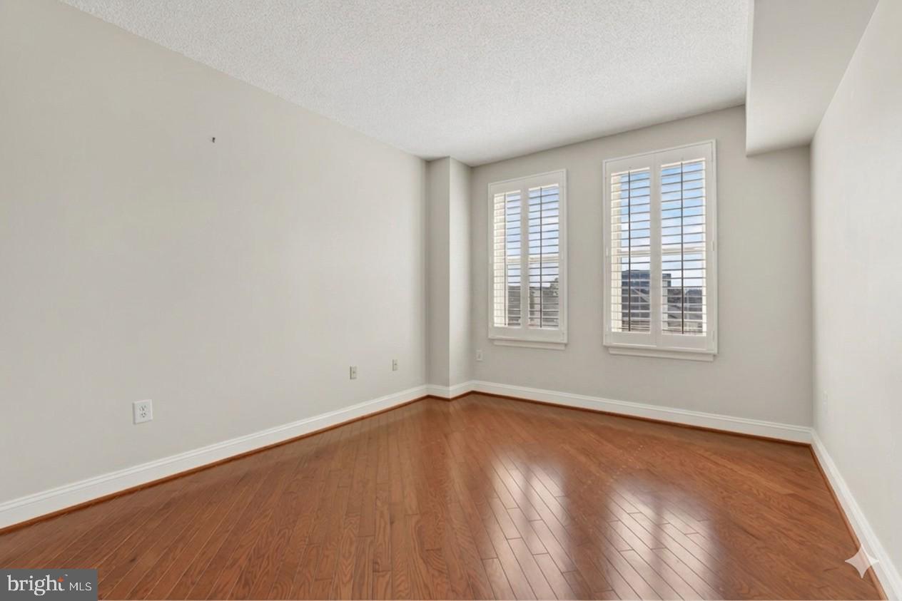 11776 Stratford House Place, Unit 502 Reston, VA 20190 - Photo 19 of 34 wooden floor in an empty room with a window
