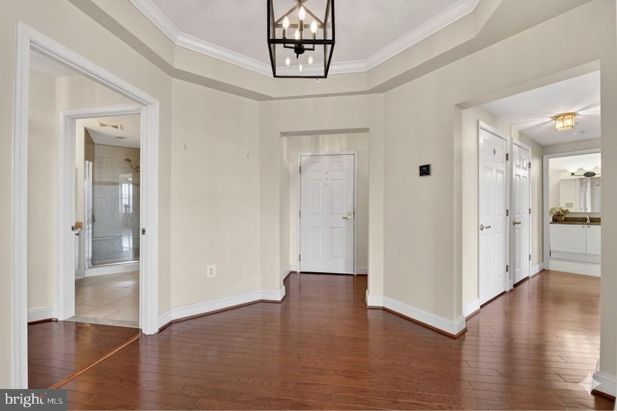 11776 Stratford House Place, Unit 502 Reston, VA 20190 - Photo 5 of 34 a view of a hallway with wooden floor
