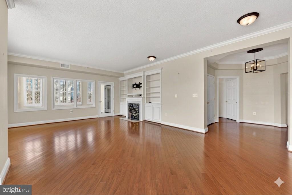 11776 Stratford House Place, Unit 502 Reston, VA 20190 - Photo 9 of 34 a view of an empty room with window and wooden floor
