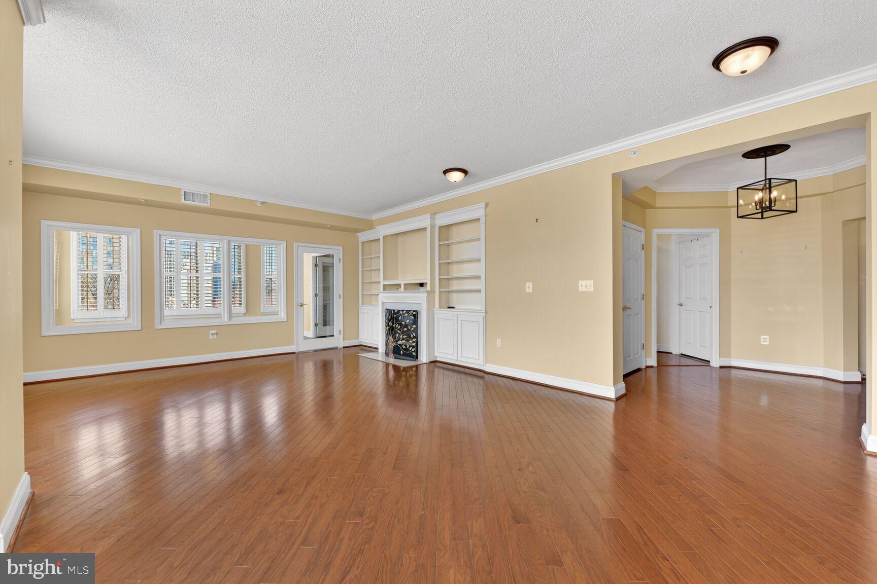 11776 Stratford House Place, Unit 502 Reston, VA 20190 - Photo 9 of 35 a view of an empty room with window and wooden floor