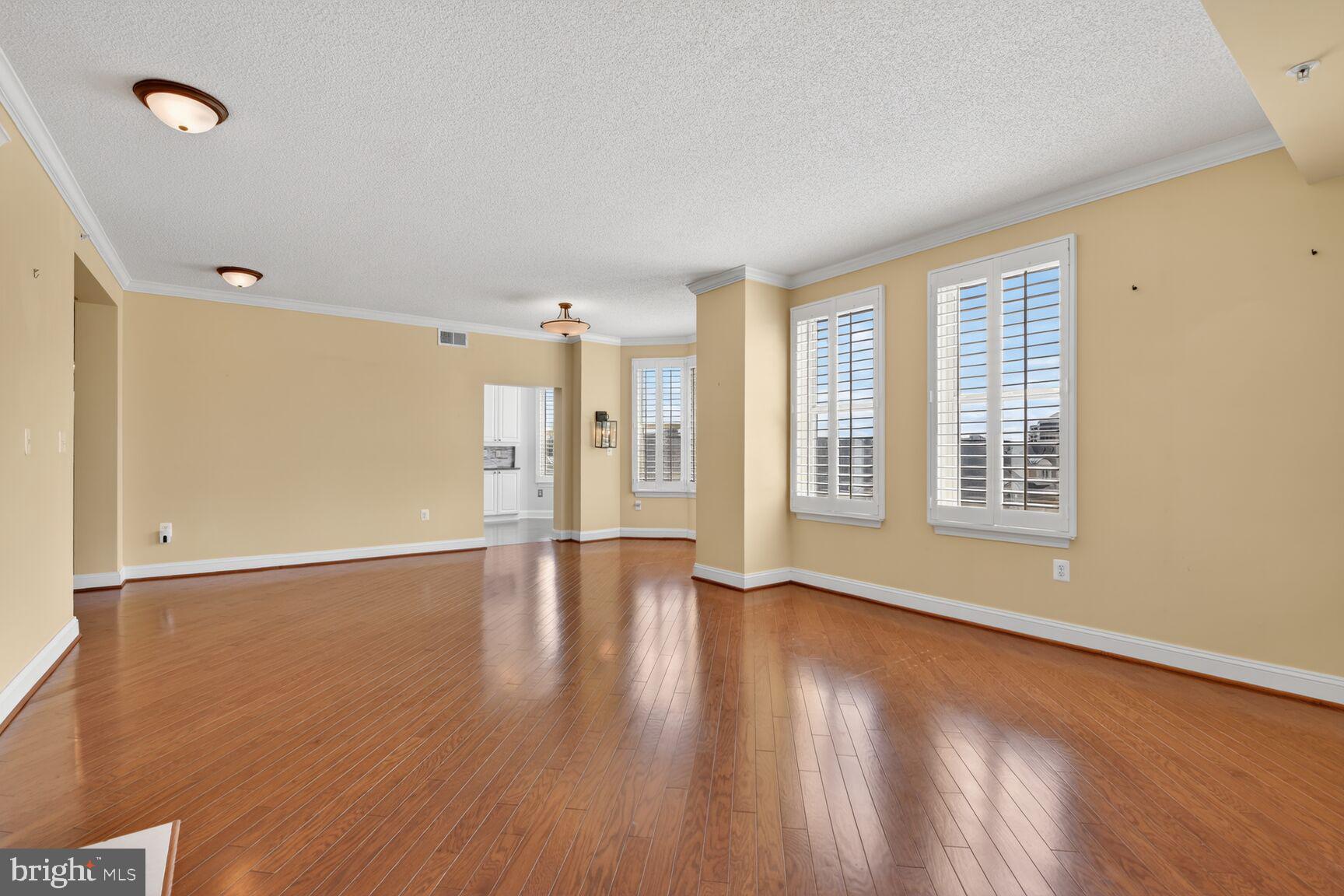 11776 Stratford House Place, Unit 502 Reston, VA 20190 - Photo 10 of 35 a view of an empty room with wooden floor and a window