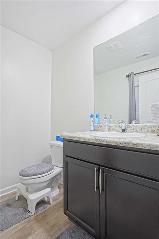 12001 Guelph Circle Hampton, GA 30228 - Photo 11 of 31 a bathroom with a granite countertop toilet sink and mirror