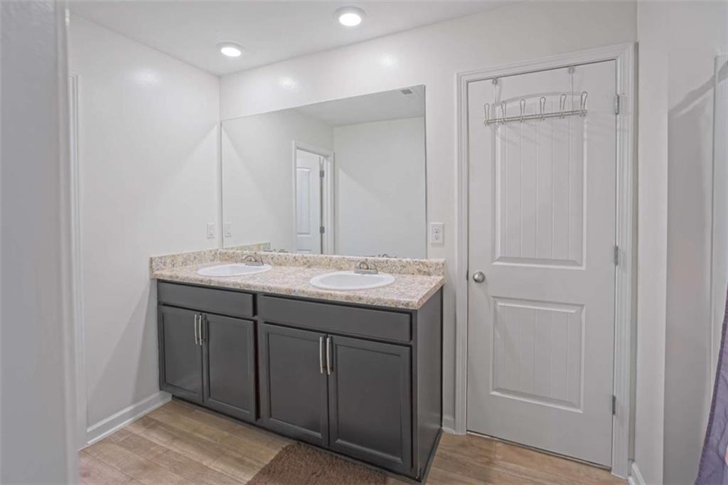 12001 Guelph Circle Hampton, GA 30228 - Photo 18 of 31 a bathroom with a granite countertop sink and a mirror