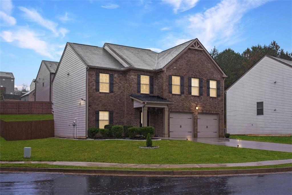 12001 Guelph Circle Hampton, GA 30228 - Photo 2 of 31 a front view of a house with a garden and plants