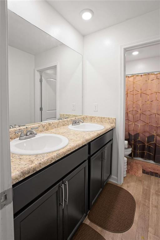 12001 Guelph Circle Hampton, GA 30228 - Photo 24 of 31 a bathroom with a granite countertop sink a mirror and a bathtub