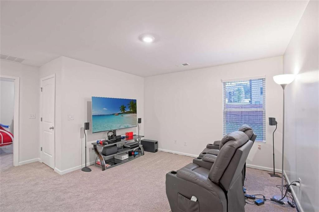 12001 Guelph Circle Hampton, GA 30228 - Photo 29 of 31 a room with furniture and a flat screen tv