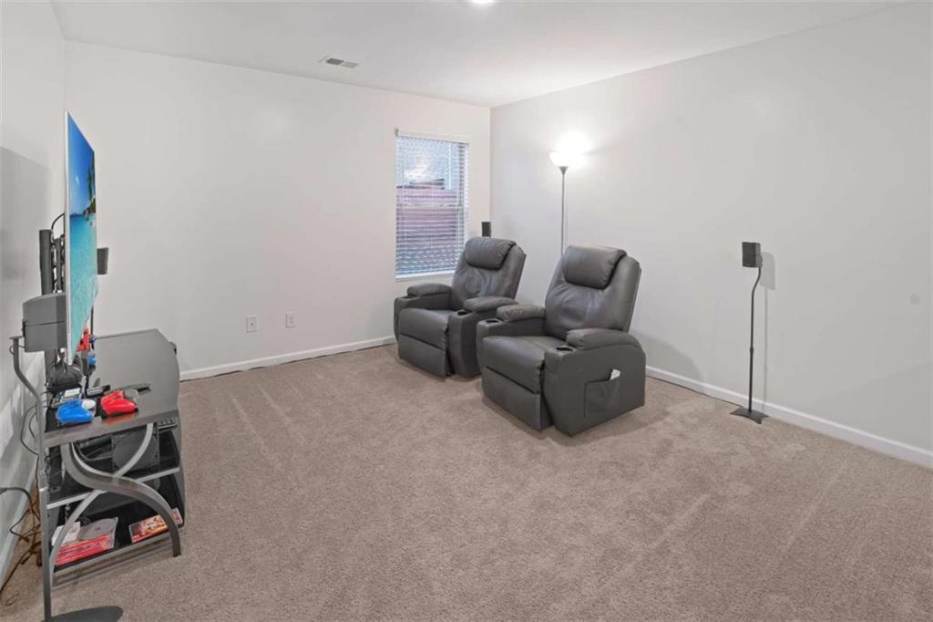 12001 Guelph Circle Hampton, GA 30228 - Photo 30 of 31 a living room with furniture and a gym cycle