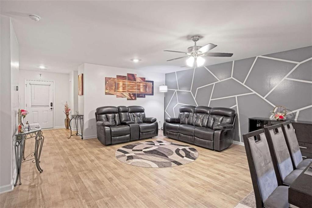 12001 Guelph Circle Hampton, GA 30228 - Photo 5 of 31 a living room with furniture a ceiling fan and a rug