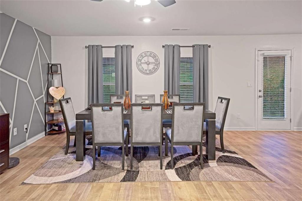 12001 Guelph Circle Hampton, GA 30228 - Photo 8 of 31 a view of a dining room with furniture window and wooden floor