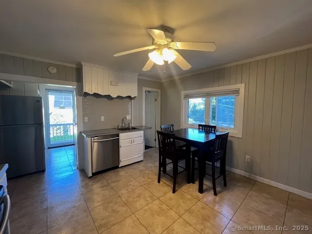a large kitchen with granite countertop a stove a sink a counter space and cabinets
