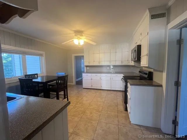 a kitchen with a refrigerator and a sink