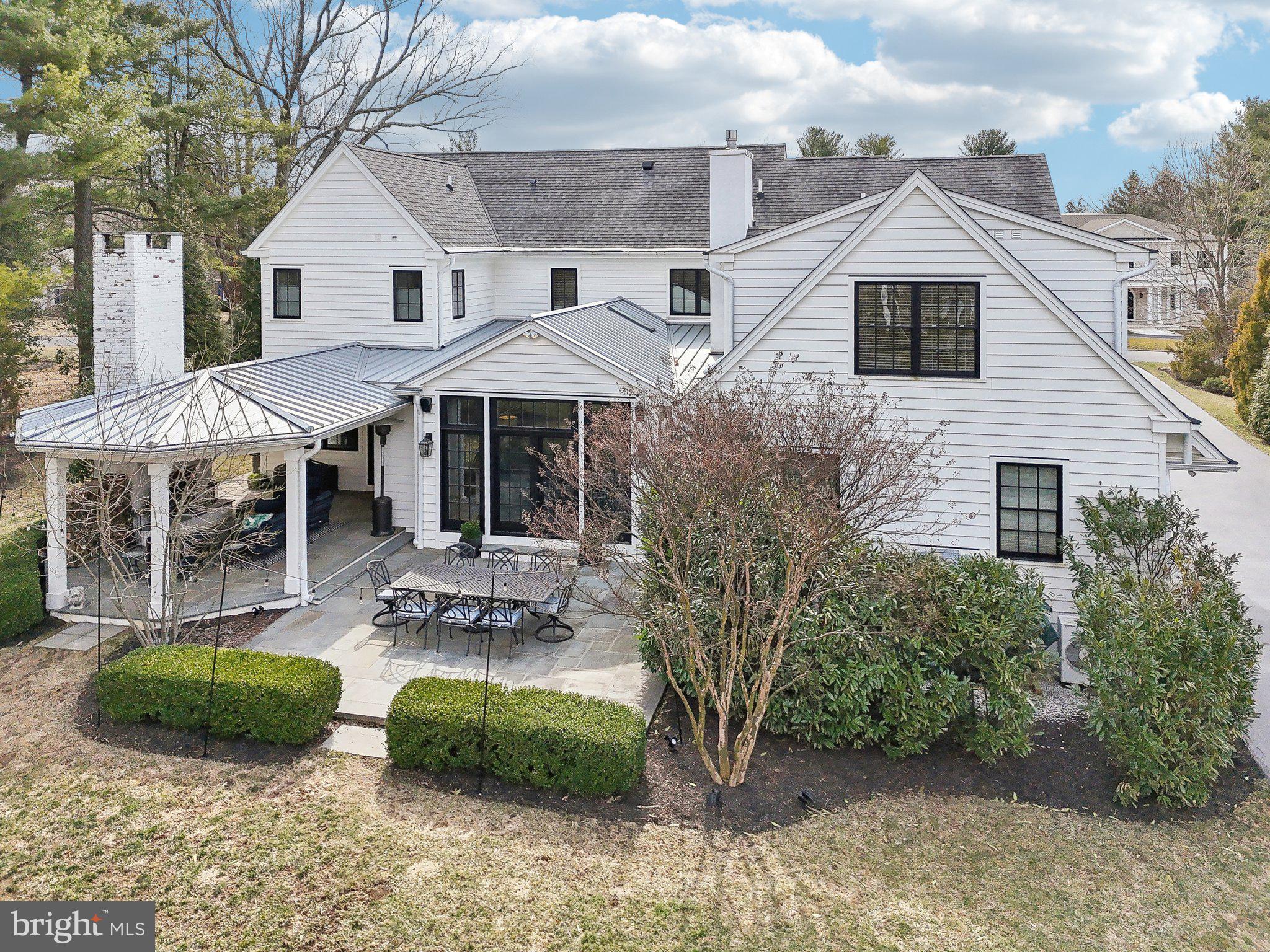 111 Steeplechase Road Devon, PA 19333 - Photo 3 of 77 a view of a white house with a chairs and table in a patio