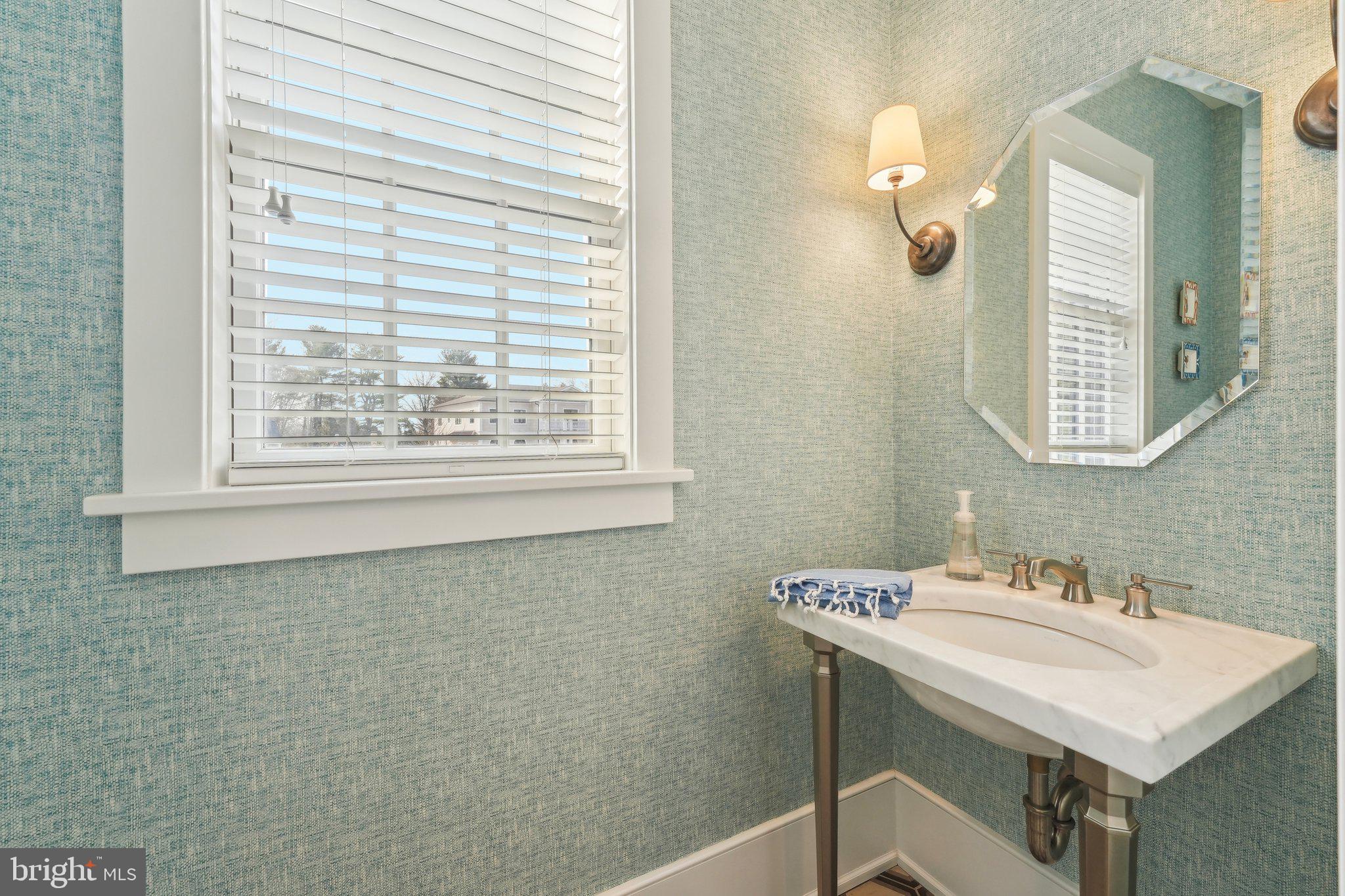 111 Steeplechase Road Devon, PA 19333 - Photo 36 of 77 a bathroom with a sink and a mirror