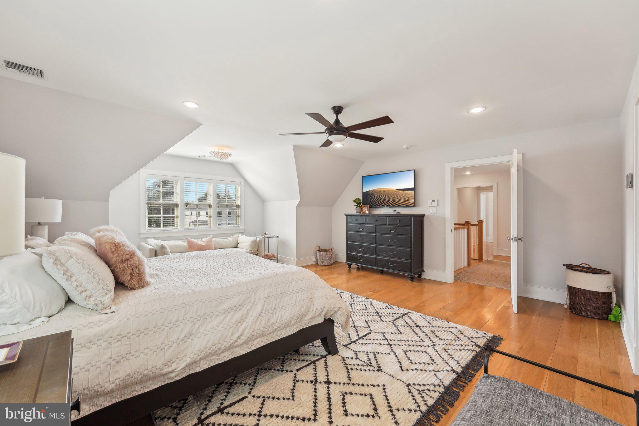 111 Steeplechase Road Devon, PA 19333 - Photo 39 of 77 a bedroom with a bed and dresser with wooden floor