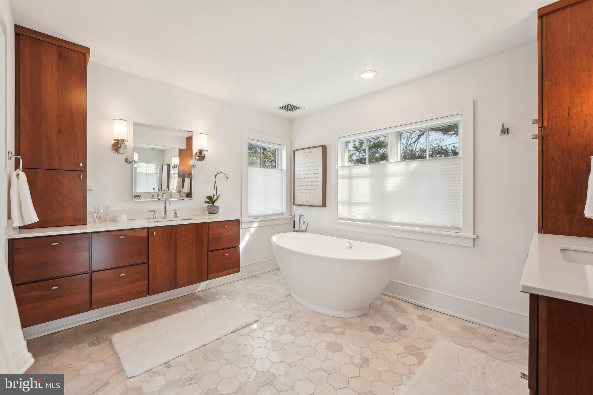 111 Steeplechase Road Devon, PA 19333 - Photo 44 of 77 a spacious bathroom with a double vanity sink a mirror and a bathtub