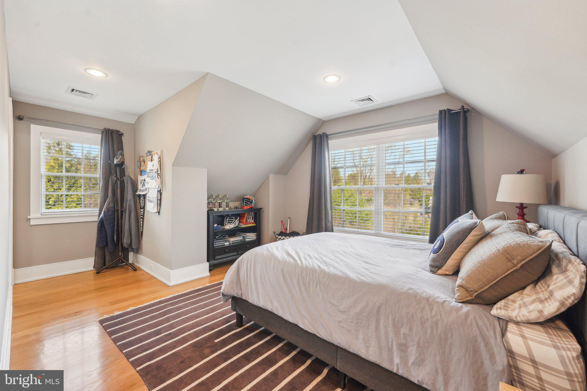 111 Steeplechase Road Devon, PA 19333 - Photo 53 of 77 a bedroom with a bed and wooden floor